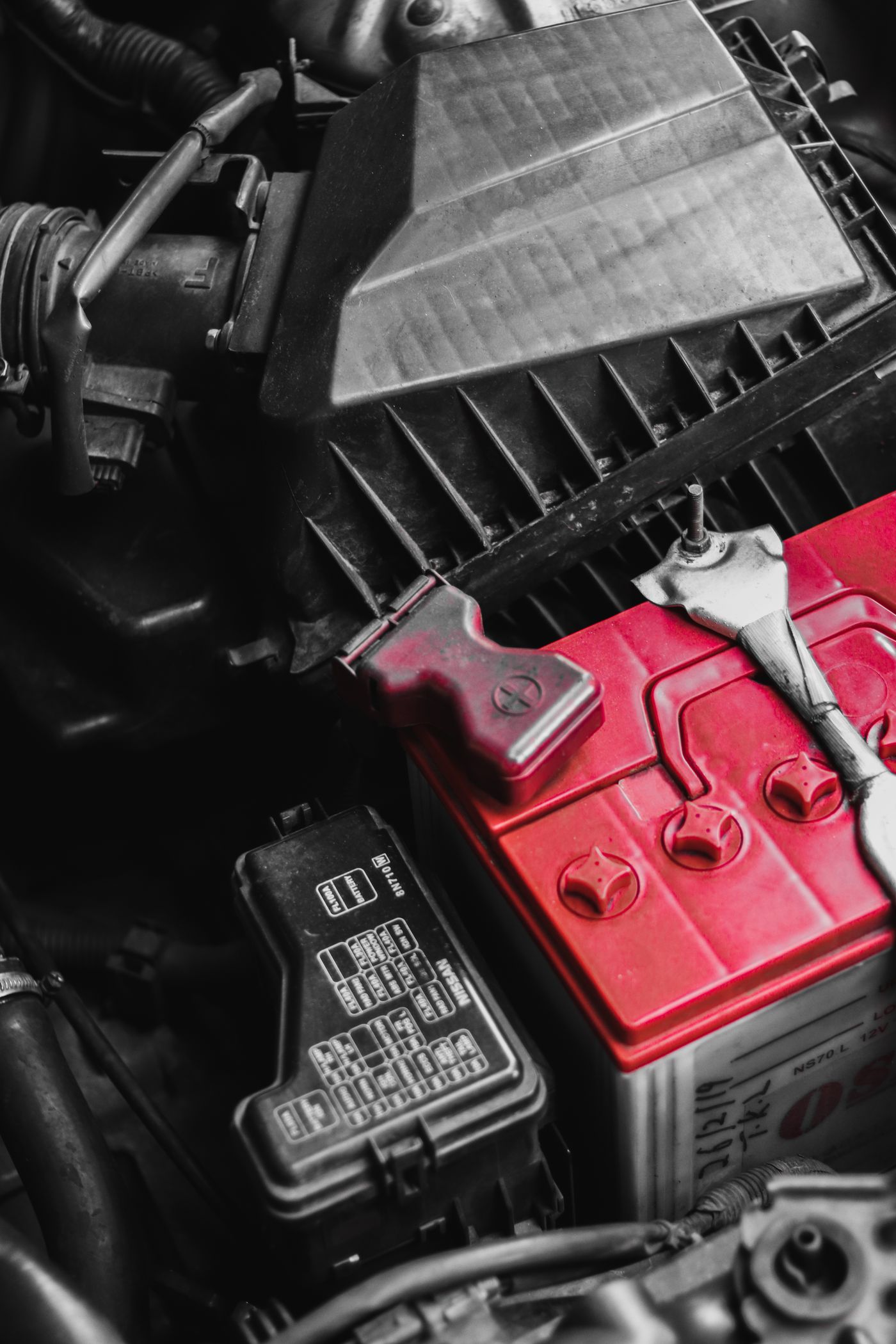 Car battery maintenance in an engine bay