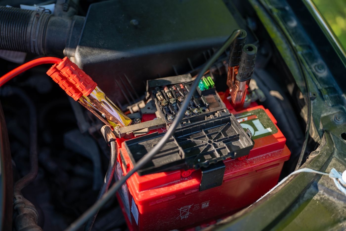 Jumper cables connected to a car battery